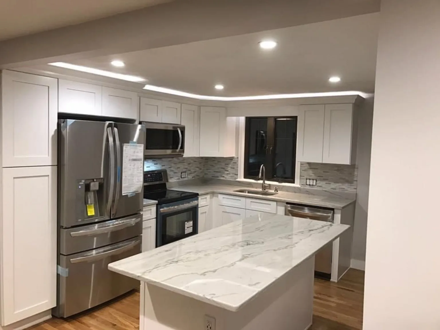 Completed white kitchen remodel with large island