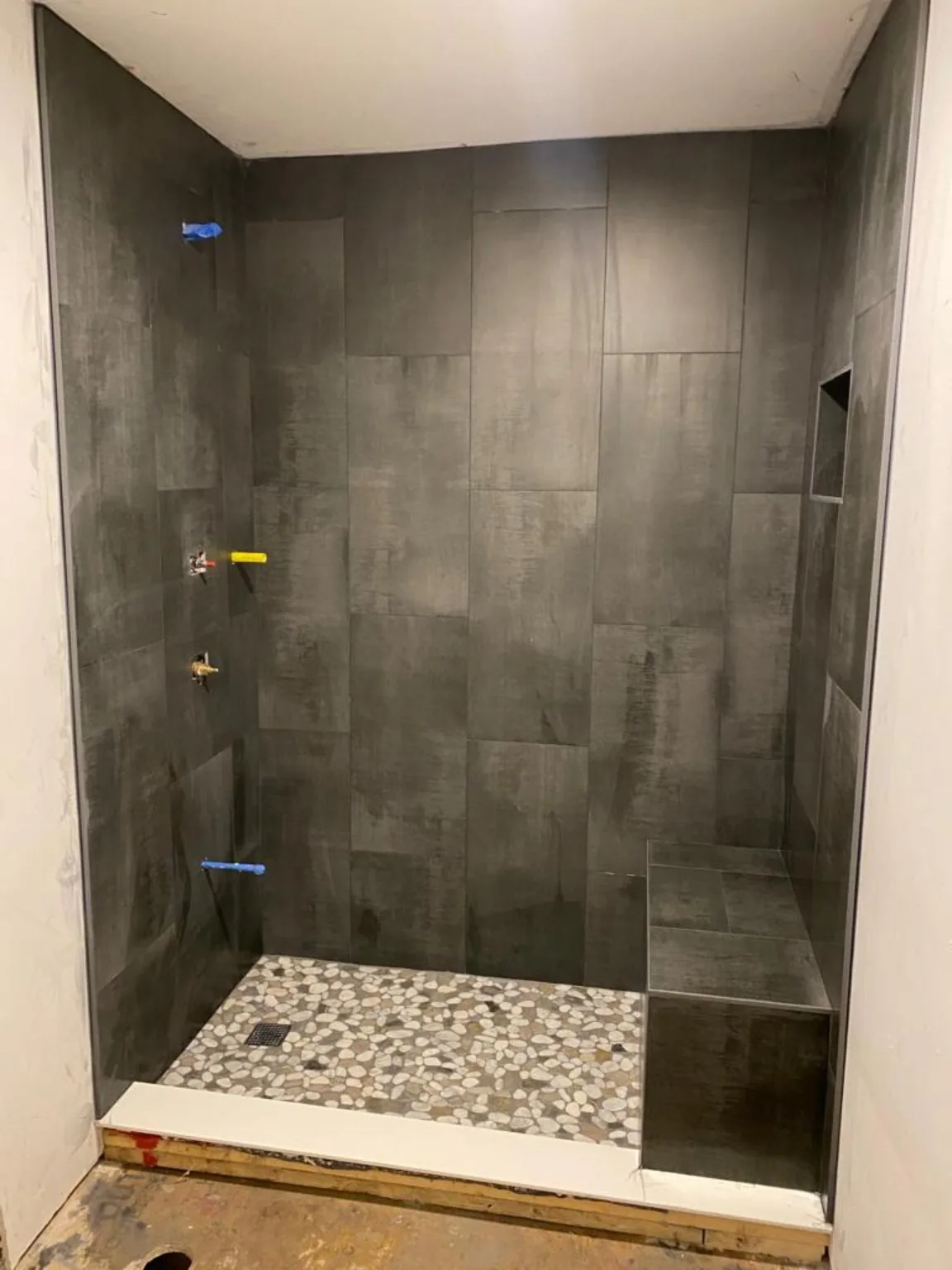 Gray shower tile work in progress
